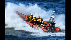 Port Erin's Atlantic 85v lifeboat leaving Peel Harbour