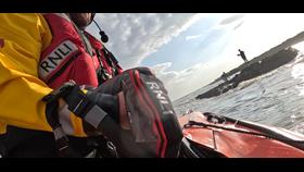 ILB approaching two people on rock