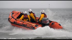 Horton's inshore lifeboat with three crew moving through the sea