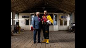 Nathan Vasudaven and his father Bhargawa standing in a Victorian pier