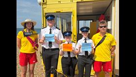 RNLI lifeguards and Sussex Police cadets distributing child-safe wristbands