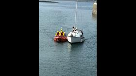 Port St Mary inshore lifeboat entering harbour with casualty