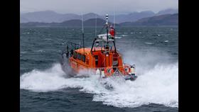 The Oban Lifeboat heading away from the camera in moderate seas and wind