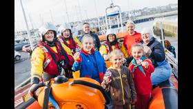 Pictured from left, Bangor RNLI crew member Christine Bell; Bangor RNLI Helm Gareth Whan; Gareth Morrison, RNLI Head of Water Safety: Bangor RNLI crew member Katherine Lindsay; Claire Flowers, Girlguiding Ulster CEO; and Felicity Atwell, Girlguiding Ulster Deputy Chief Commissioner. Front from left, Faye Charington, 1st Comber Guides; Evie Bell, 1st Comber C Brownies; and Charlotte Maidment, 14th Bangor Rainbows.