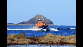 Sennen Cove Tamar Class Lifeboat ' City of London III' returning to Sennen Cove with Cowloe rocks in the forground and the Brisons in the background. Taken on a previous occasion.
