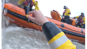 POV head cam footage of crew in water looking up at inshore lifeboat