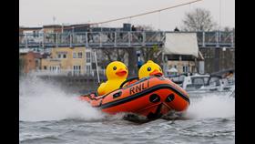 Two plastic ducks in a lifeboat