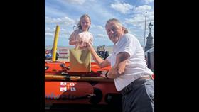 Grace Irish being presented with her prize by Phil Lay Penarth LOM whilst sat on the D-Class in front of the station