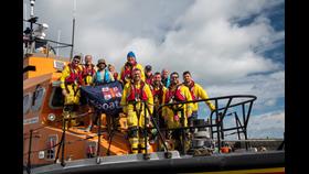 Endurance runner Vini Cardoso on board the Howth All-Weather Lifeboat with the volunteer crew of Howth RNLI after he returned to Howth completing his 6 week coastal running challenge.