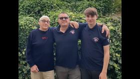 Three people in RNLI branded sweaters with Pat Leigh, Peter Leigh and Samuel Leigh.