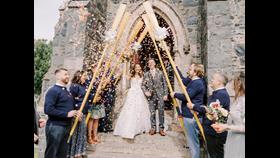 The couple can be seen leaving the church with crew members lining both sides of the steps forming a guard of honour with the oars.
