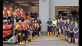 21 volunteer crew from Littlehampton RNLI pose for a photo outside the lifeboat station