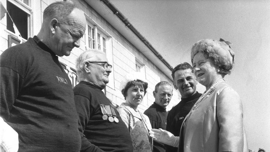 9 May 1969. The Queen Mother visits the Isles of Scilly. Coxswain Matthew Lethbridge Jnr introduces the St Mary's crew and their wives.