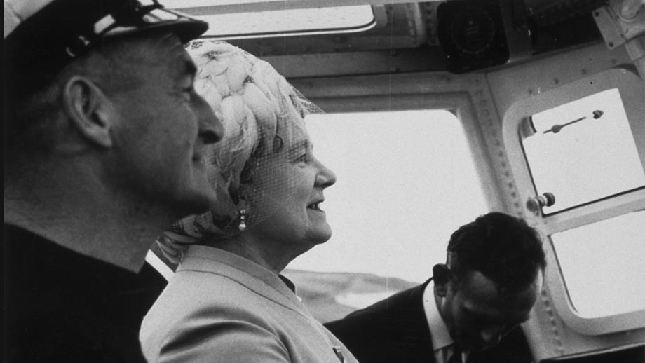 11 Aug 1971. The Queen Mother takes the wheel of Thurso's new lifeboat The Three Sisters under the guidance of Coxswain Gilbert Reid at the naming ceremony