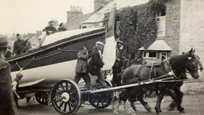 1933: Newquay RNLI’s self-righting class lifeboat, Admiral Sir George Back, being towed through the streets on a carriage by horses