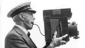 Black and white picture of Frank Beken holding his camera.