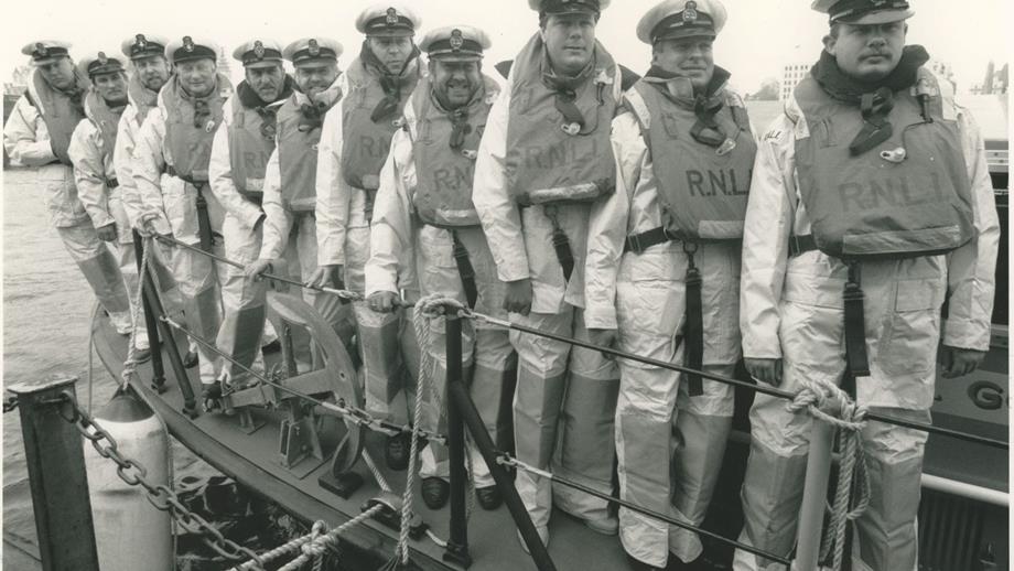 Black and white image of eleven crew onboard lifeboat