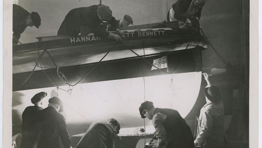 Black and white image of lifeboat maintenance being undertaken