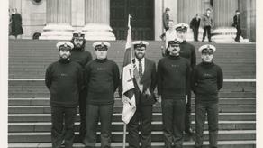Black and white image of crew including flagbearer outside St Paul's Cathedral