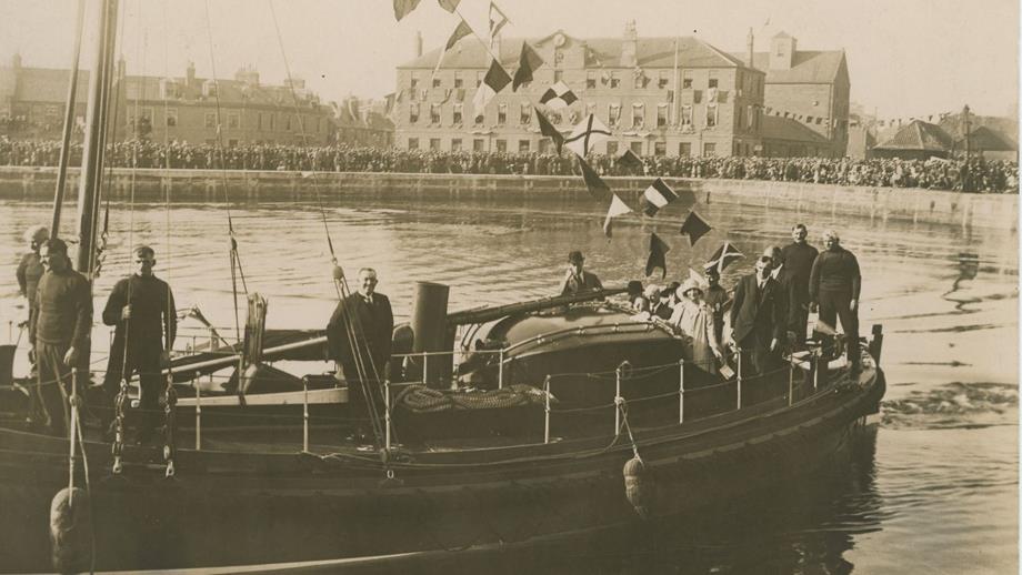 Black and white image of Duke and Duchess of York onboard lifeboat