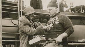 Black and white image of crew member and street collector