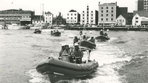 Black and white image of five inshore lifeboats