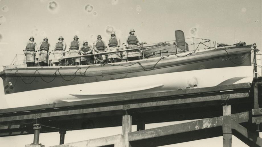 Black and white image of crew inside Humber lifeboat on slipway