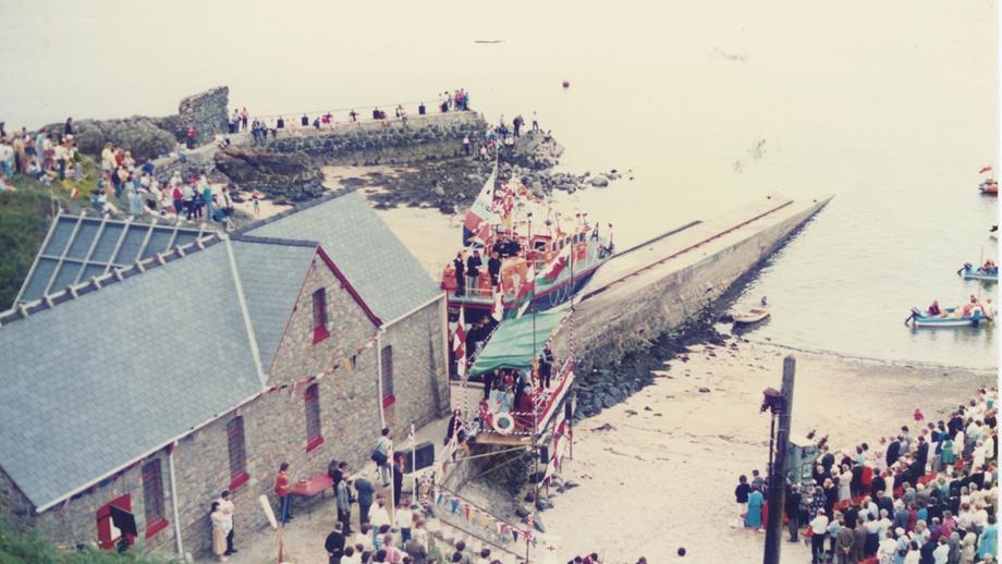 Colour image of lifeboat on slipway with naming ceremony audience alongside