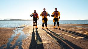 Three crew members standing on the slipway at Largs