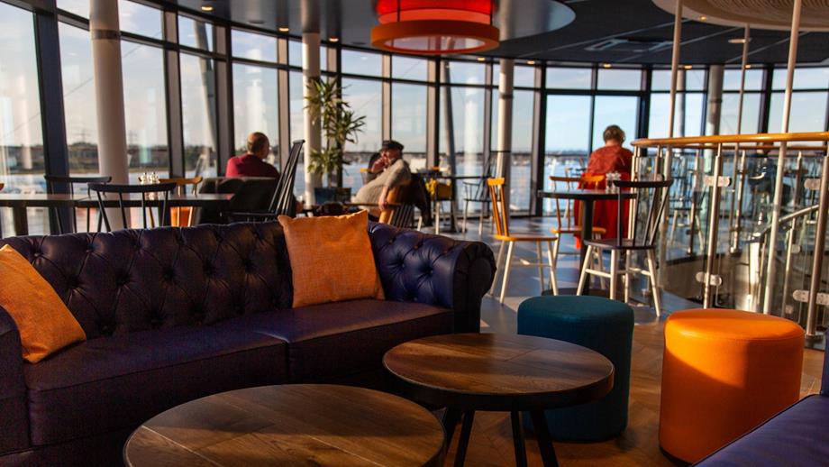 A serene lounge area atop the building, offering a stunning view of the water below, perfect for relaxation and enjoyment.