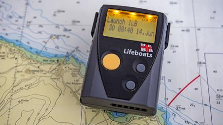 A pager laying on top of a map.