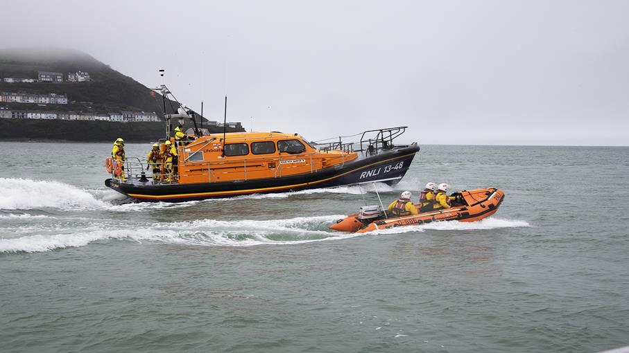 New Quay Shannon class all-weather lifeboat Roy Barker V 13-48 and D-class inshore lifeboat Will Morgan D-886 at sea during a training exercise.