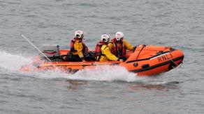 Image of Little and Broadhaven's D Class lifeboat at speed in the water with three crew members onboard