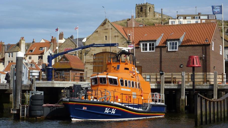 RNLI Whitby Lifeboat Station with the station’s Trent class all-weather lifeboat, George and Mary Webb 14-14, moored outside