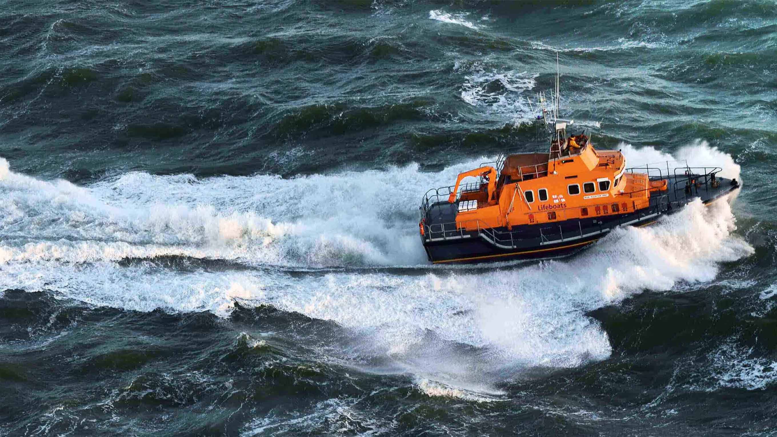 Severn class lifeboat breaking through waves