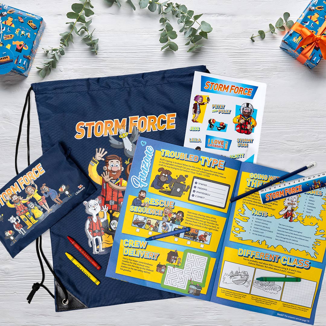 Overview of the contents of Storm Force membership pack. On display are the Storm Force magazine, pencil case and drawstring bag.