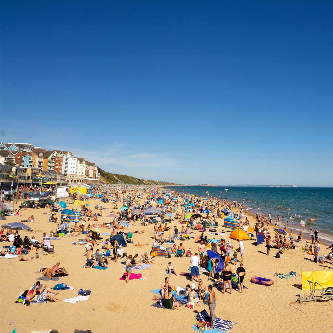 Photo of a busy beach in Boscombe during the summer lifeguard season. 