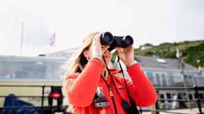 lifeguard Bethan Phillips looks through binoculars