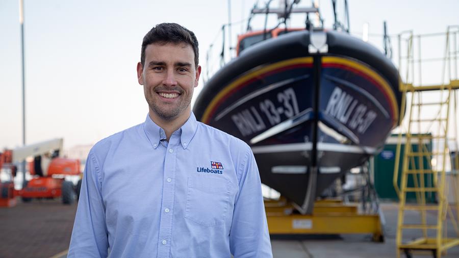 Daniel Sharp, RNLI Production Control Manager, in front of a Shannon class lifeboat