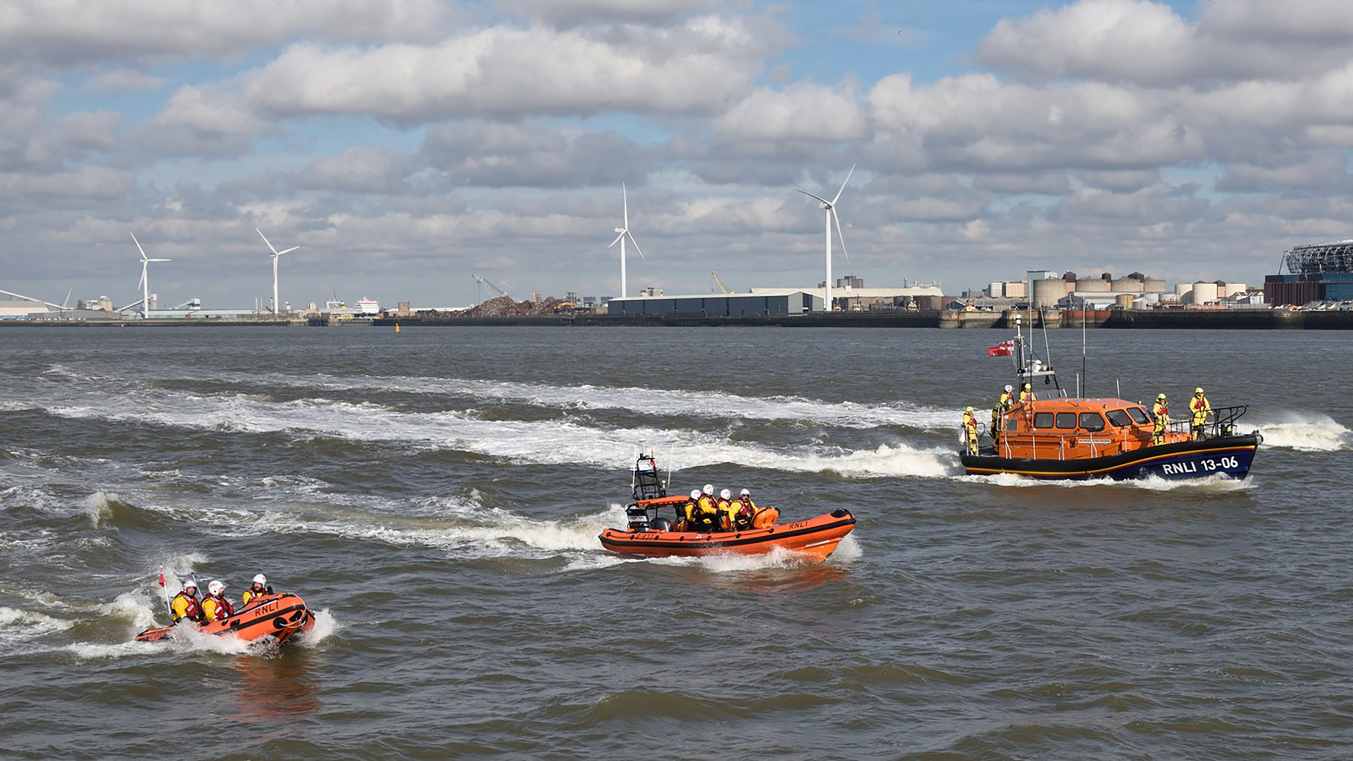 Three lifeboats powering down the River Mersey – one Shannon class lifeboat, a B class lifeboat and a D class lifeboat
