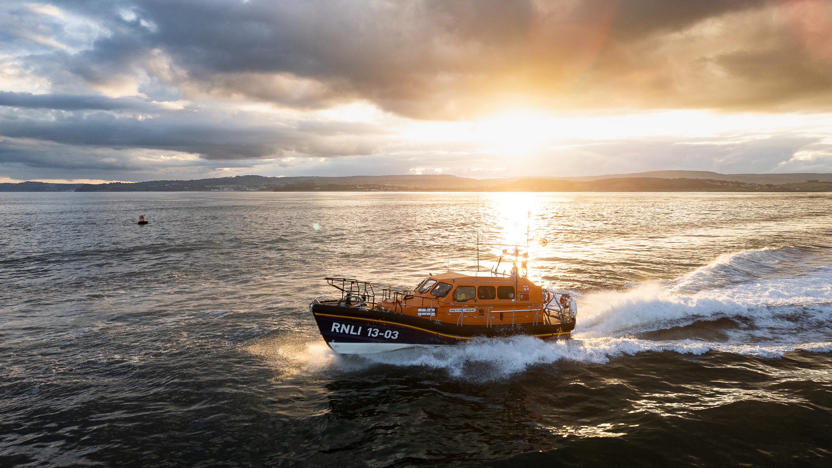 Exmouth’s Shannon class lifeboat R and J Welburn on the water at sunset