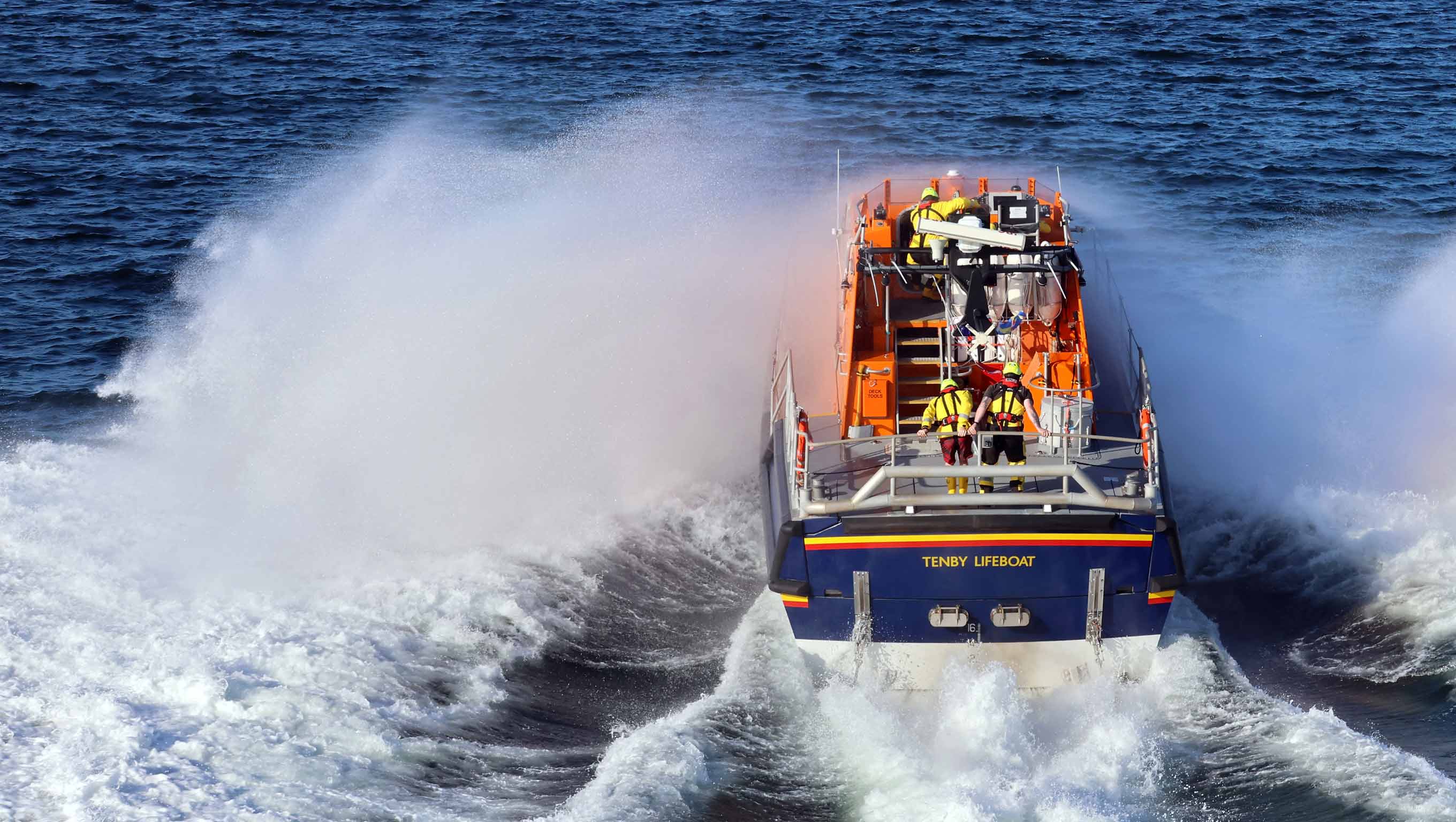 Tenby's all-weather lifeboat launches from the slipway into the surf on the way to a rescue