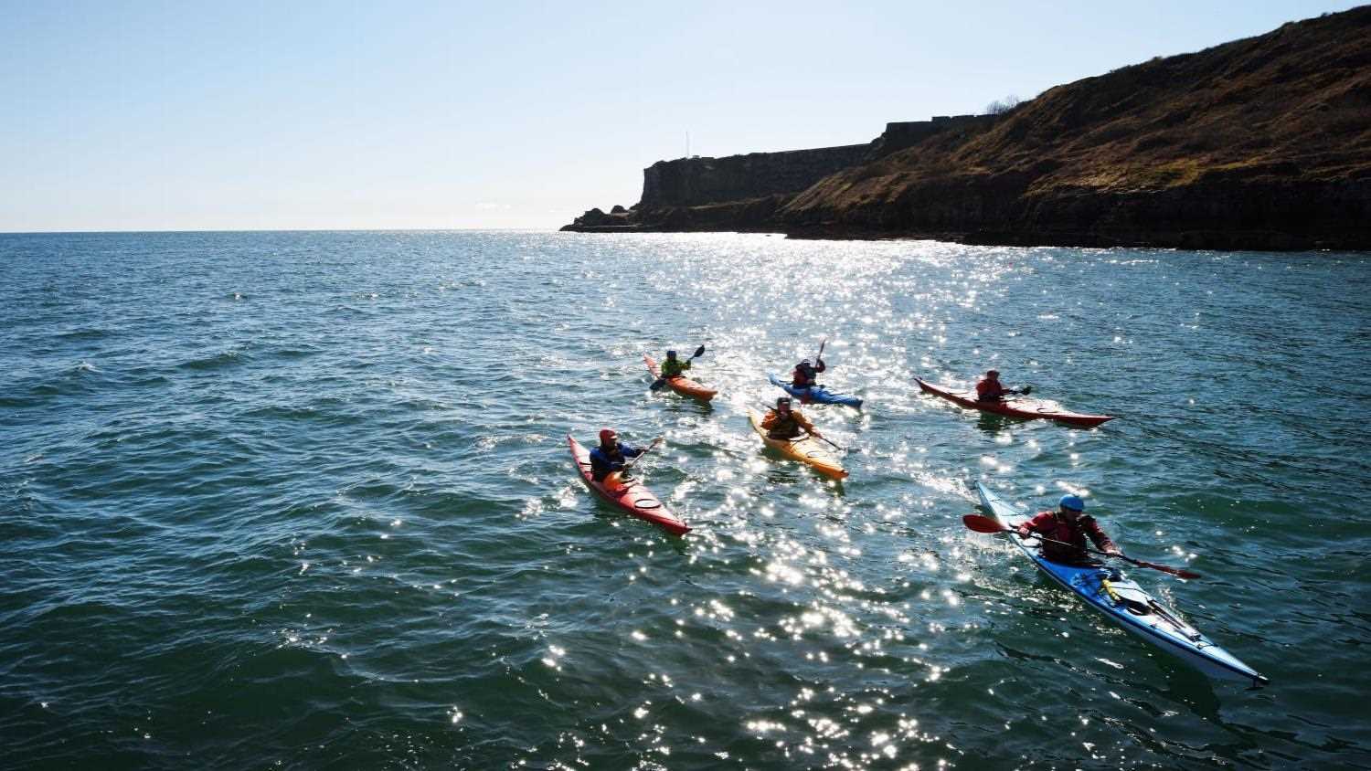 Kayakers out at sea in Torbay, Devon