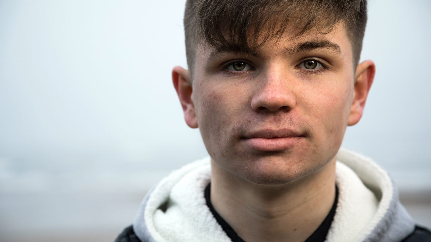 Close portrait of Evan looking at camera, telling his story of how Float to Live saved his life