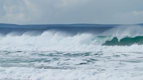 A large wave breaking at Porthtowan Beach