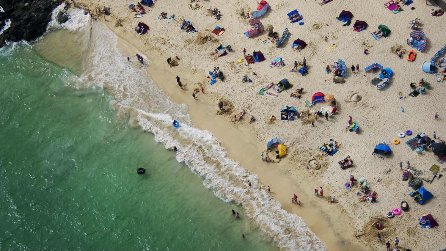 Aerial view of a busy beach on a sunny day