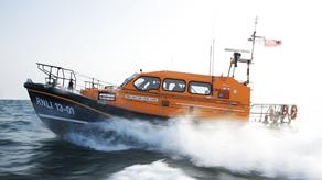 The Shannon class lifeboat cutting through the waves creating a lot of spray