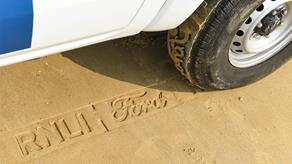 Ford vehicle with RNLI track tires should the words 'RNLI, Ford' in the sand