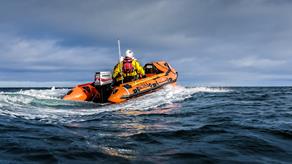 Dunbar's inshore lifeboat heading out to sea on a cloudy day