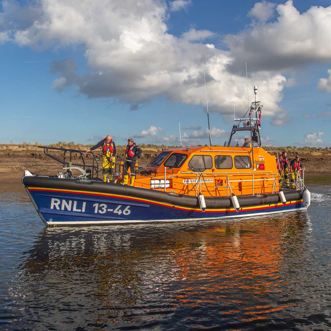 The Wells lifeboat on a calm sea in the sunshine.
